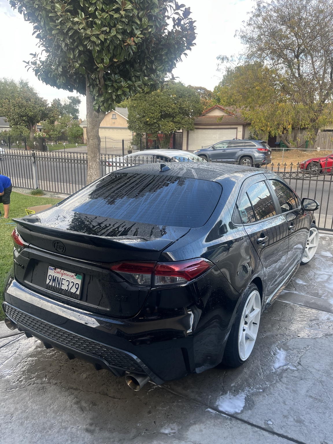WIWW practice: rear view of the wet black Corolla and white wheels
